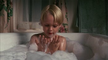 Movie still from “Dennis the Menace” (1993), directed by Nick Castle – A young child in a bath tub playing with soap; Close Up shot, High angle