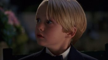 Movie still from “Dennis the Menace” (1993), directed by Nick Castle – A child wearing a suit and bow tie; Close Up shot, Low angle