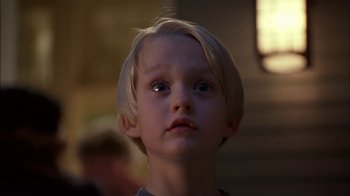 Movie still from “Dennis the Menace” (1993), directed by Nick Castle – A young child looking up; Close Up shot, Low angle
