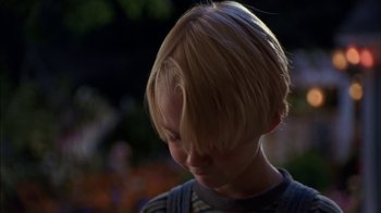 Movie still from “Dennis the Menace” (1993), directed by Nick Castle – A child's head with a blurry background; Close Up shot, Low angle