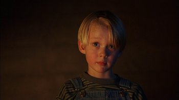 Movie still from “Dennis the Menace” (1993), directed by Nick Castle – A little boy with blonde hair wearing a striped shirt; Close Up shot, Low angle
