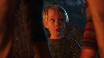 Movie still from “Dennis the Menace” (1993), directed by Nick Castle – A little boy standing in front of a tree; Close Up shot, Low angle
