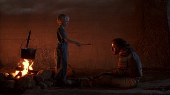 Movie still from “Dennis the Menace” (1993), directed by Nick Castle – A man and a boy are playing with a wand; Medium shot, Over the shoulder angle