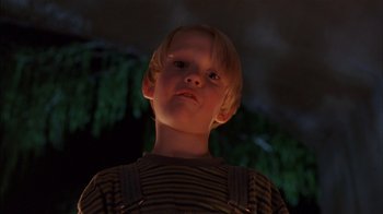 Movie still from “Dennis the Menace” (1993), directed by Nick Castle – A young boy is looking up at the sky at night; Close Up shot, Low angle