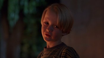 Movie still from “Dennis the Menace” (1993), directed by Nick Castle – A little boy that is standing up in the dark; Close Up shot, Low angle