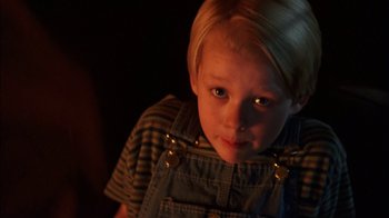 Movie still from “Dennis the Menace” (1993), directed by Nick Castle – A little boy with blond hair and a striped t - shirt; Close Up shot, High angle