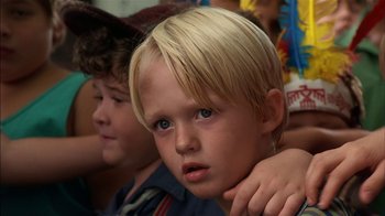 Movie still from “Dennis the Menace” (1993), directed by Nick Castle – A young boy with his hand on his shoulder; Close Up shot, Low angle
