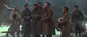 Movie still from “Dersu Uzala” (1975), directed by Akira Kurosawa – A group of men standing next to each other holding guns; Medium shot, Low angle
