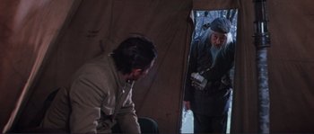 Movie still from “Dersu Uzala” (1975), directed by Akira Kurosawa – A man and a woman standing in front of a tent; Medium shot, Over the shoulder angle