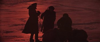 Movie still from “Dersu Uzala” (1975), directed by Akira Kurosawa – A group of people standing next to each other on a beach; Wide shot, High angle