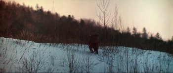 Movie still from “Dersu Uzala” (1975), directed by Akira Kurosawa – A moose walking across a snow covered field; Extreme Wide shot, High angle