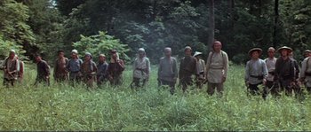 Movie still from “Dersu Uzala” (1975), directed by Akira Kurosawa – A group of people standing in a field; Wide shot, High angle
