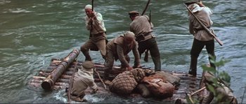 Movie still from “Dersu Uzala” (1975), directed by Akira Kurosawa – A group of men on a raft in a body of water; Wide shot, High angle