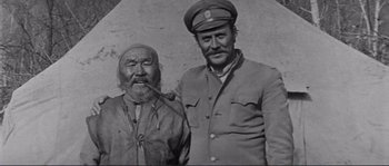 Movie still from “Dersu Uzala” (1975), directed by Akira Kurosawa – A man and a man with a hat on; Medium shot, Overhead angle