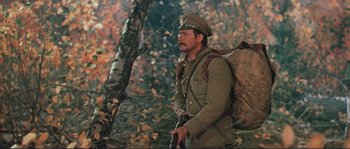 Movie still from “Dersu Uzala” (1975), directed by Akira Kurosawa – A man in a military uniform is holding a rifle; Medium shot, Low angle