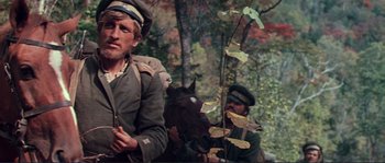 Movie still from “Dersu Uzala” (1975), directed by Akira Kurosawa – Two men in military garb are riding a horse; Medium shot, Low angle