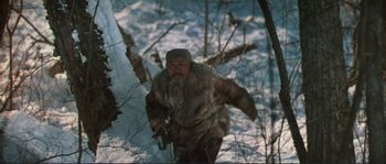 Movie still from “Dersu Uzala” (1975), directed by Akira Kurosawa – A man in a fur coat is walking through the snow; Medium shot, High angle