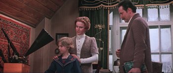 Movie still from “Dersu Uzala” (1975), directed by Akira Kurosawa – A woman and a boy are standing in front of a window; Medium shot, Low angle