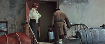 Movie still from “Dersu Uzala” (1975), directed by Akira Kurosawa – A man and a woman are standing in front of a door; Medium shot, Low angle