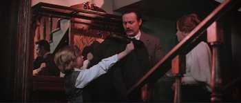 Movie still from “Dersu Uzala” (1975), directed by Akira Kurosawa – A young boy helping a man fix a tie; Medium shot, Over the shoulder angle