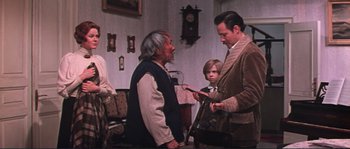 Movie still from “Dersu Uzala” (1975), directed by Akira Kurosawa – Two men and a boy in a living room; Medium shot, Over the shoulder angle