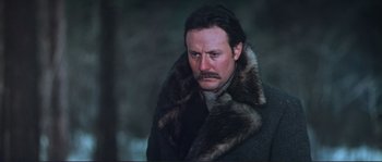 Movie still from “Dersu Uzala” (1975), directed by Akira Kurosawa – A person wearing a coat with a fur collar; Close Up shot, Low angle