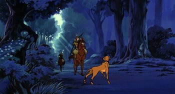 Movie still from “The Last Unicorn” (1982), directed by Jules Bass – A man riding a horse with a dog on the back of it; Wide shot, Low angle