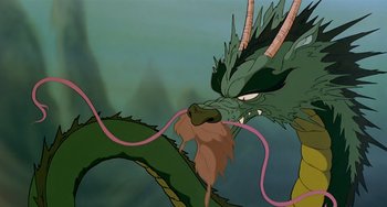 Movie still from “The Last Unicorn” (1982), directed by Jules Bass – An animated picture of a green dragon with a pink tail; Close Up shot, High angle