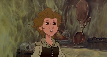 Movie still from “The Last Unicorn” (1982), directed by Jules Bass – A woman with curly brown hair is looking at the camera; Close Up shot, Over the shoulder angle