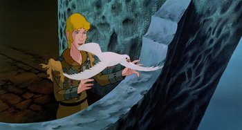 Movie still from “The Last Unicorn” (1982), directed by Jules Bass – A painting of a man holding a white bird in front of a waterfall; Medium shot, Low angle