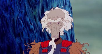 Movie still from “The Last Unicorn” (1982), directed by Jules Bass – An old man with long white hair is depicted in a cartoon; Close Up shot, Low angle