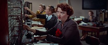 Movie still from “Designing Woman” (1957), directed by Vincente Minnelli – A group of women sitting at a table; Medium shot, Low angle