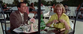 Movie still from “Designing Woman” (1957), directed by Vincente Minnelli – A man and a woman sitting at an outdoor table; Medium shot, Over the shoulder angle