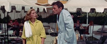 Movie still from “Designing Woman” (1957), directed by Vincente Minnelli – A man and a woman standing next to each other; Medium shot, Low angle