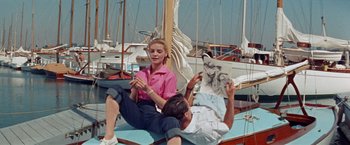 Movie still from “Designing Woman” (1957), directed by Vincente Minnelli – A man and a woman sitting on a boat; Wide shot, High angle