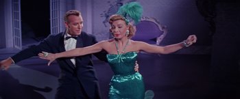 Movie still from “Designing Woman” (1957), directed by Vincente Minnelli – A man and a woman dancing in a green dress; Medium shot, Low angle