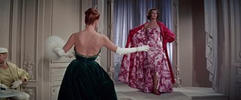 Movie still from “Designing Woman” (1957), directed by Vincente Minnelli – A woman in a green dress and a woman in a pink dress; Medium shot, Low angle
