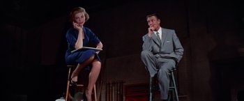 Movie still from “Designing Woman” (1957), directed by Vincente Minnelli – A man and a woman sitting next to each other; Medium shot, Low angle
