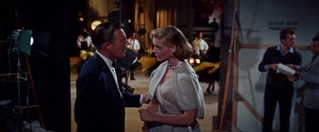 Movie still from “Designing Woman” (1957), directed by Vincente Minnelli – A man and a woman are talking to each other; Medium shot, Over the shoulder angle