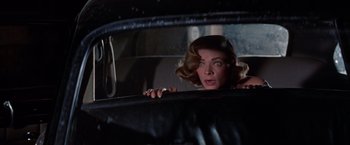 Movie still from “Designing Woman” (1957), directed by Vincente Minnelli – A woman in the back seat of a car looking out the window; Close Up shot, Over the shoulder angle