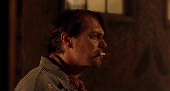 Movie still from “Desperado” (1995), directed by Robert Rodriguez – A person smoking a cigarette; Close Up shot, Low angle