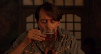 Movie still from “Desperado” (1995), directed by Robert Rodriguez – A man is drinking a glass of water; Close Up shot, High angle