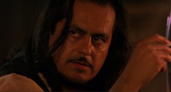 Movie still from “Desperado” (1995), directed by Robert Rodriguez – A person with long black hair; Close Up shot, Over the shoulder angle