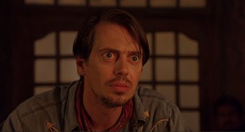 Movie still from “Desperado” (1995), directed by Robert Rodriguez – A person looking at the camera; Close Up shot, Low angle