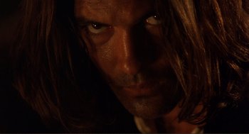 Movie still from “Desperado” (1995), directed by Robert Rodriguez – A man with long hair; Extreme Close Up shot, Low angle