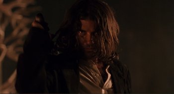 Movie still from “Desperado” (1995), directed by Robert Rodriguez – A person with long brown hair; Close Up shot, Low angle