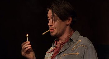 Movie still from “Desperado” (1995), directed by Robert Rodriguez – A man holding a burning match in his mouth; Close Up shot, Low angle