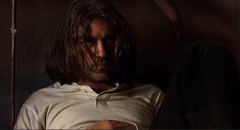 Movie still from “Desperado” (1995), directed by Robert Rodriguez – A person with long brown hair; Close Up shot, Low angle