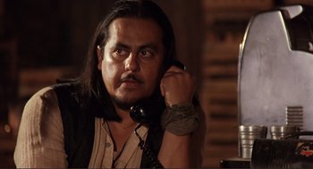 Movie still from “Desperado” (1995), directed by Robert Rodriguez – A man with long black hair talking on a phone; Close Up shot, Over the shoulder angle