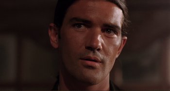 Movie still from “Desperado” (1995), directed by Robert Rodriguez – A man's face in a dark room; Close Up shot, Low angle